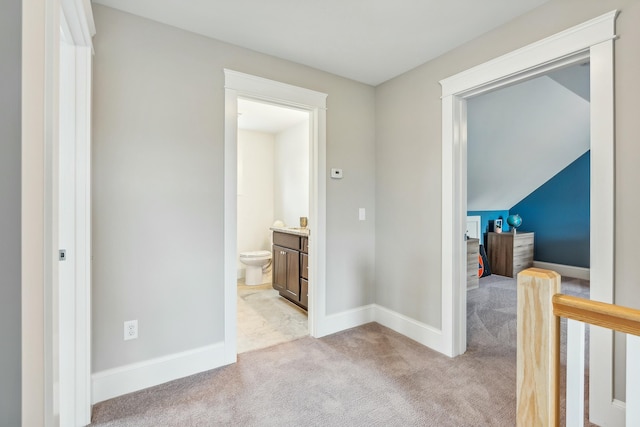 corridor featuring light colored carpet