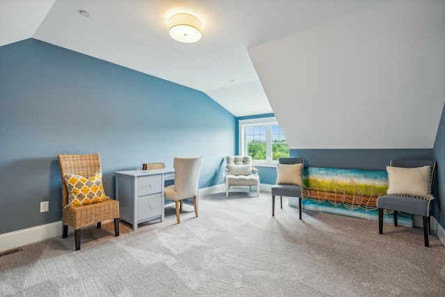 living area featuring vaulted ceiling and light colored carpet