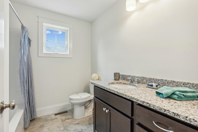 full bathroom with vanity, shower / bath combo, and toilet