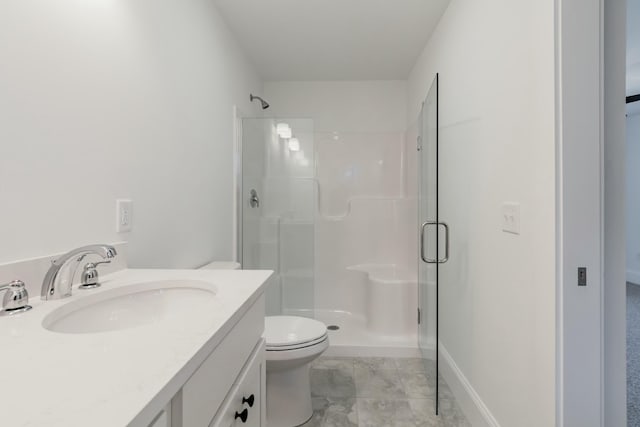 bathroom with an enclosed shower, vanity, and toilet