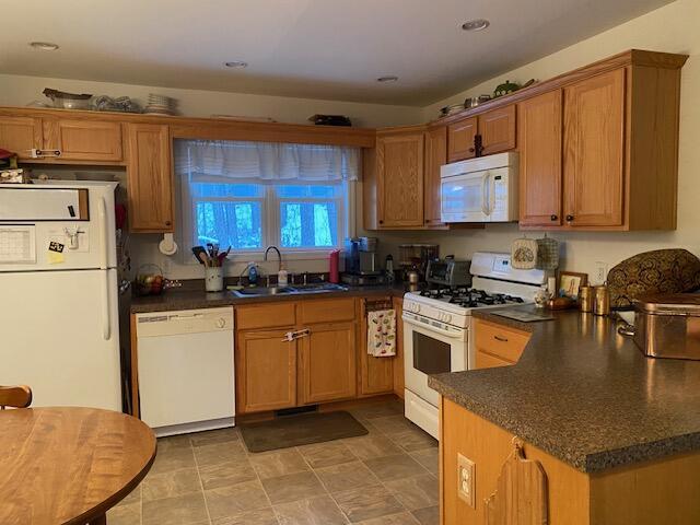 kitchen with sink and white appliances