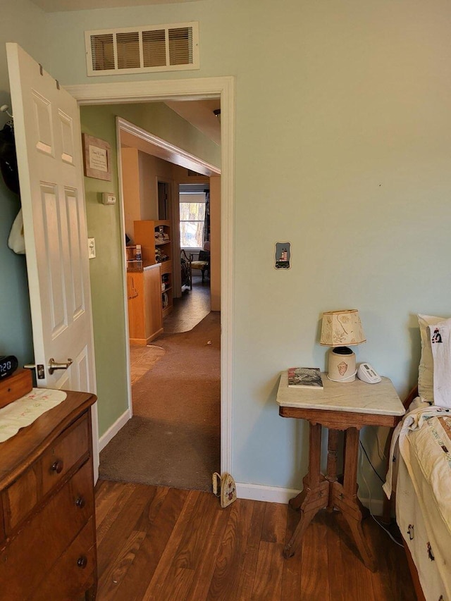 bedroom with dark wood-type flooring