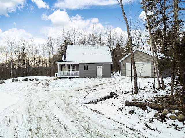 view of front of property featuring an outbuilding, a porch, and a garage