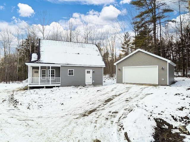 exterior space with a garage, an outdoor structure, and covered porch