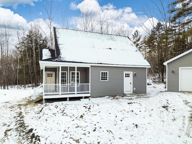 snow covered property featuring covered porch