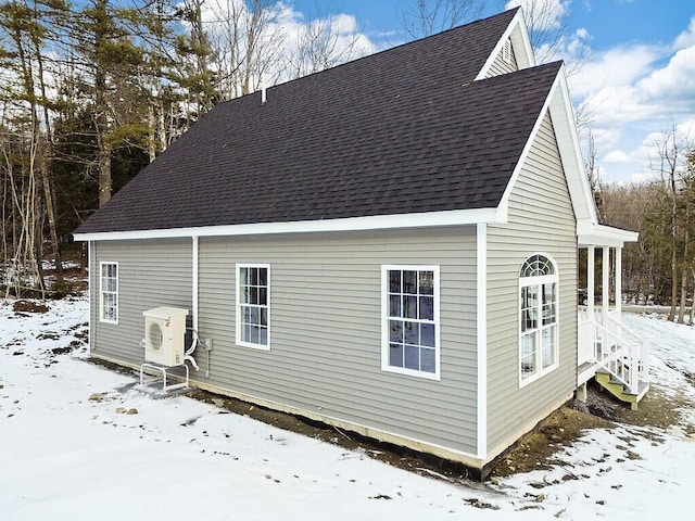 view of snow covered exterior with ac unit