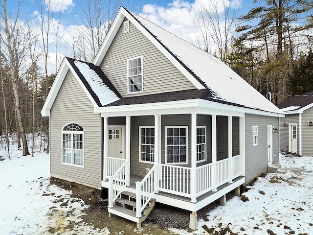 view of snow covered back of property