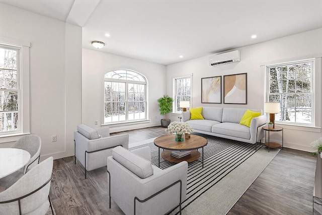 living room with plenty of natural light, dark wood-type flooring, and a wall unit AC