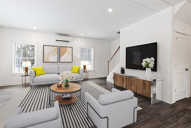 living room with dark wood-type flooring and an AC wall unit