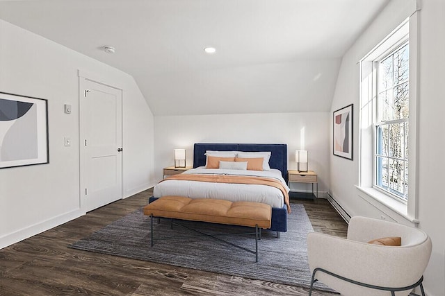 bedroom with a baseboard radiator, lofted ceiling, and dark wood-type flooring