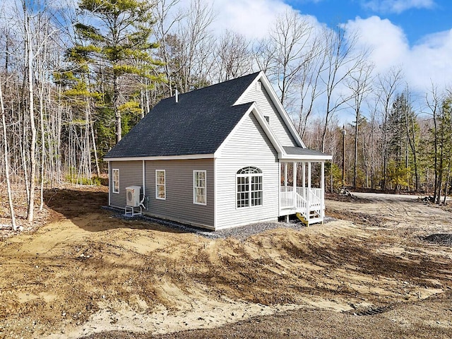 view of side of home featuring a shingled roof