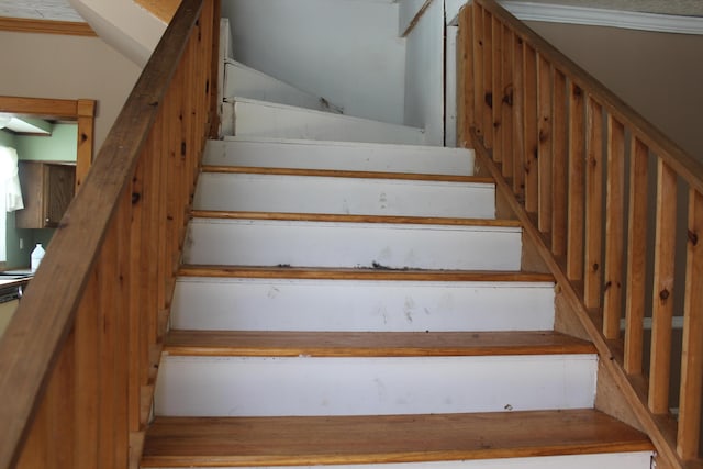 staircase featuring crown molding