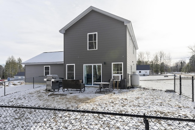 view of snow covered rear of property