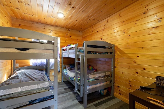 bedroom featuring wooden walls and wooden ceiling