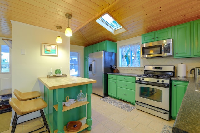 kitchen featuring green cabinets, appliances with stainless steel finishes, wooden counters, and a wealth of natural light