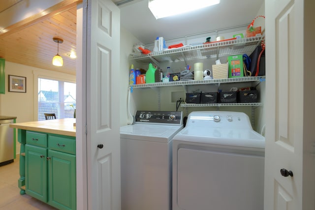 clothes washing area with washing machine and dryer