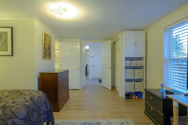 bedroom with crown molding and light hardwood / wood-style flooring