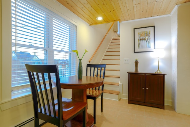 dining area featuring crown molding, a baseboard heating unit, light tile patterned flooring, and wooden ceiling