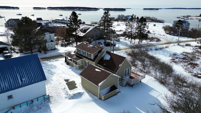 snowy aerial view featuring a water view