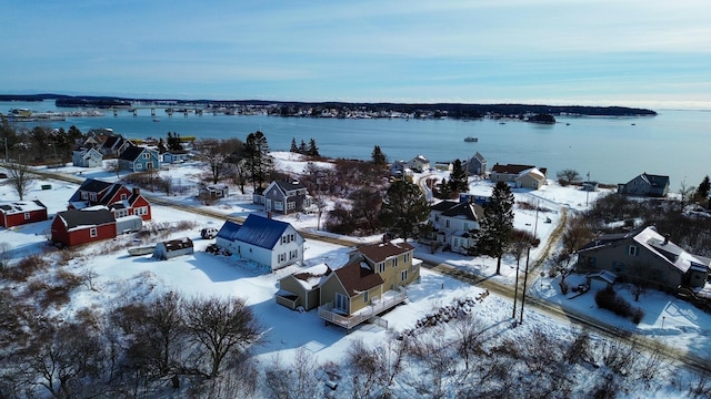 snowy aerial view featuring a water view