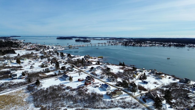 snowy aerial view with a water view