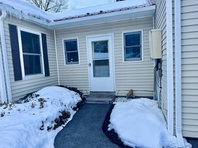 view of snow covered property entrance