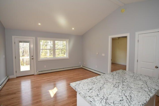 bedroom with access to outside, lofted ceiling with beams, a baseboard radiator, and light wood-type flooring