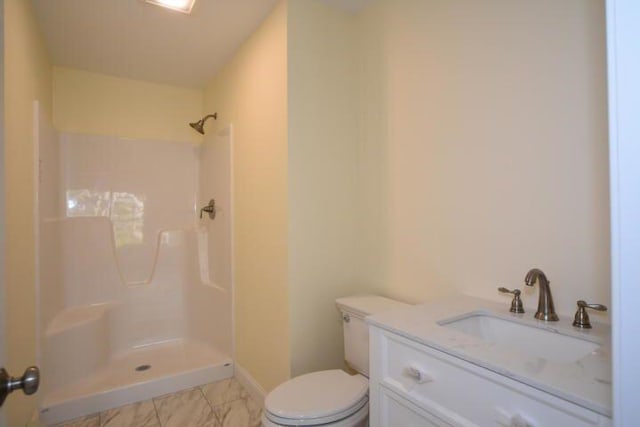 bathroom featuring walk in shower, vanity, and toilet