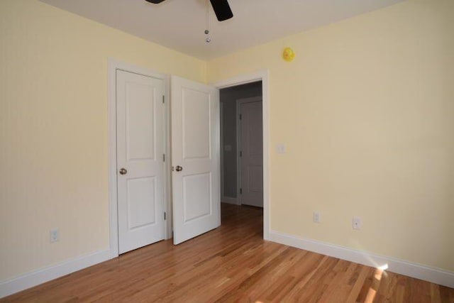 unfurnished bedroom with ceiling fan and light hardwood / wood-style floors