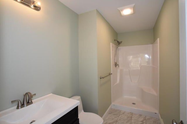 bathroom featuring walk in shower, vanity, and toilet