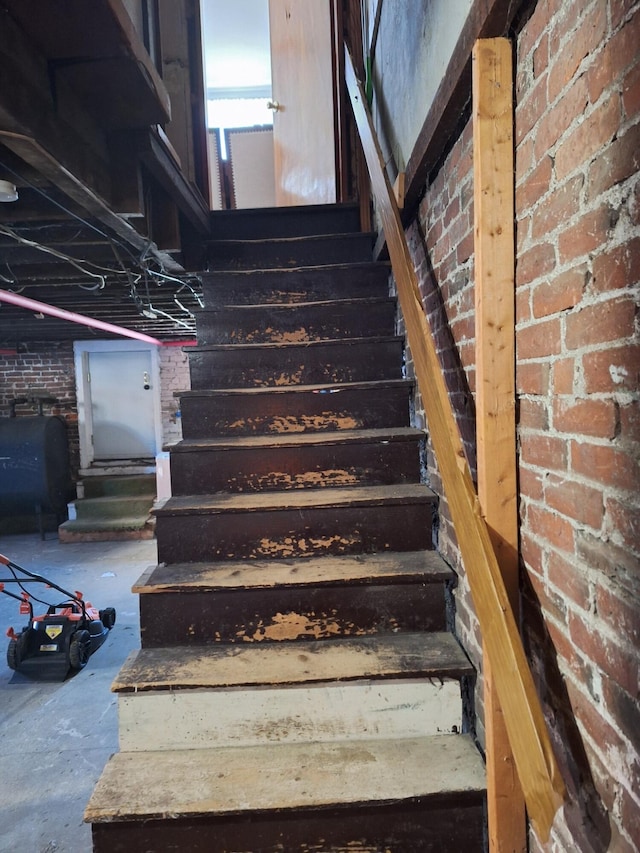 stairs with brick wall and concrete floors