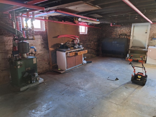 basement with brick wall and washer / clothes dryer