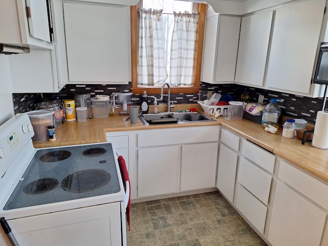 kitchen featuring white cabinetry, sink, white range with electric stovetop, and decorative backsplash