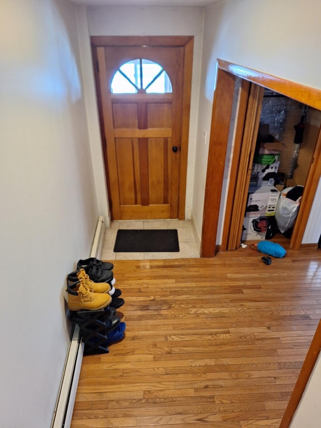 doorway to outside with a baseboard heating unit and light hardwood / wood-style flooring