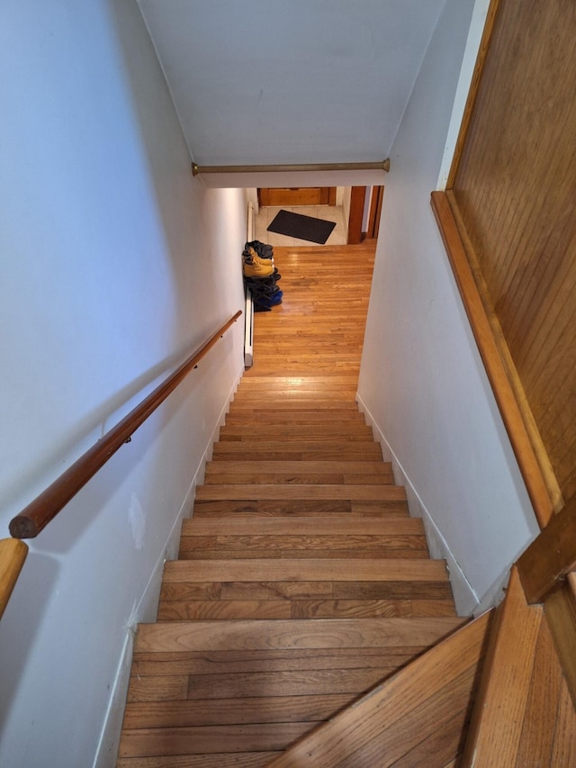 stairs featuring hardwood / wood-style flooring