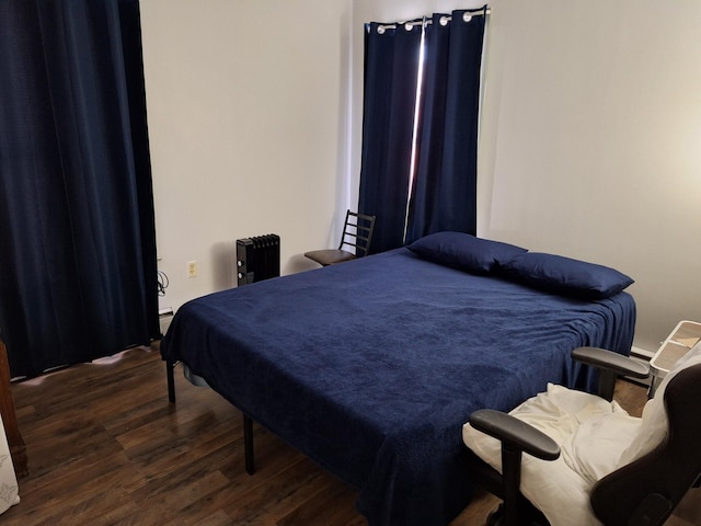 bedroom featuring dark hardwood / wood-style flooring