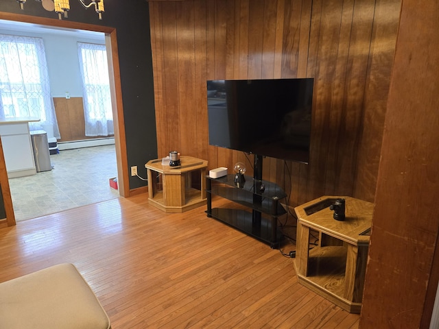 36 Erchles St, Rumford, ME 04276 - living room with wood walls, baseboards, wood finished floors, and a baseboard radiator