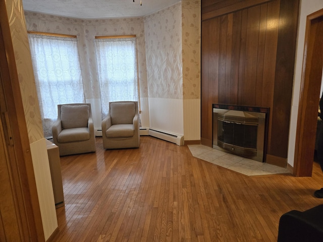 36 Erchles St, Rumford, ME 04276 - living area with wallpapered walls, hardwood / wood-style flooring, and baseboard heating