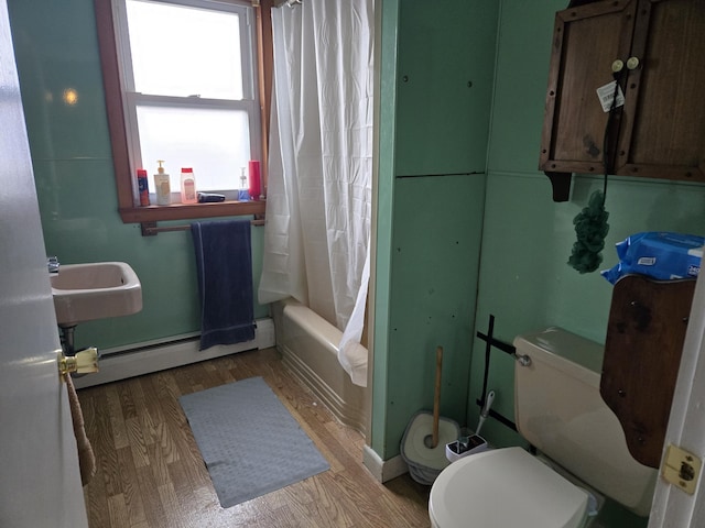36 Erchles St, Rumford, ME 04276 - full bath featuring a baseboard heating unit, shower / bath combo, a sink, toilet, and wood finished floors