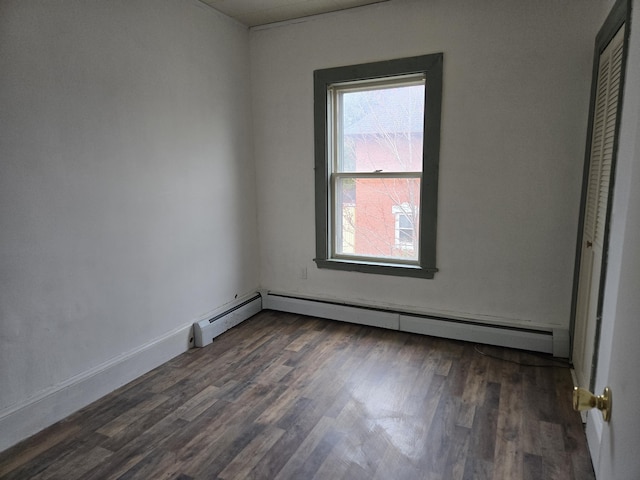 36 Erchles St, Rumford, ME 04276 - empty room featuring a baseboard heating unit and dark wood-style floors