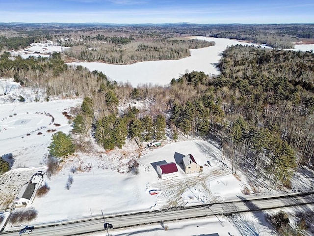 snowy aerial view with a forest view