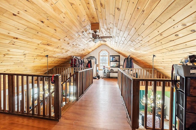 hallway featuring lofted ceiling, dark wood-type flooring, and wooden ceiling