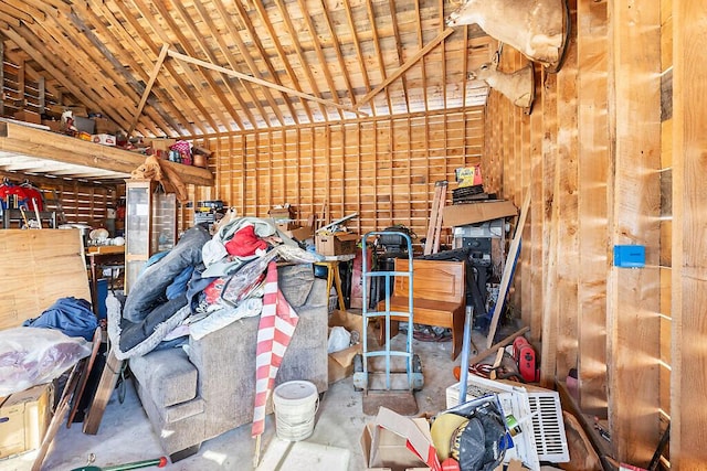 garage featuring wooden ceiling and wood walls