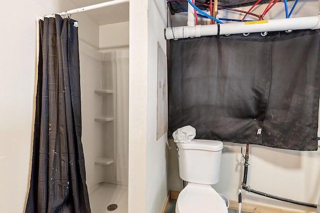 bathroom featuring toilet and walk in shower