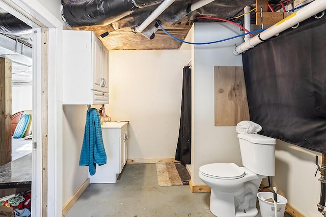 bathroom featuring concrete flooring and toilet