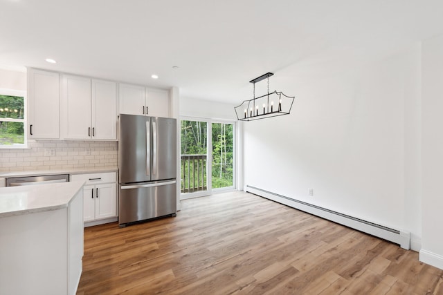 LOT9 Westhaven Ln, Wells, ME 04090 - kitchen with stainless steel appliances, backsplash, white cabinets, and a baseboard radiator