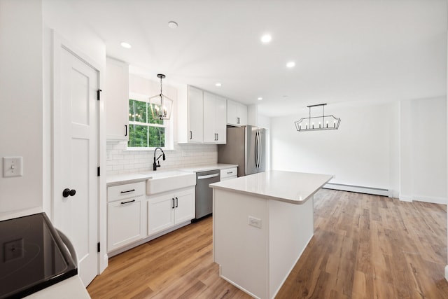 LOT9 Westhaven Ln, Wells, ME 04090 - kitchen featuring a baseboard heating unit, a sink, appliances with stainless steel finishes, and a chandelier