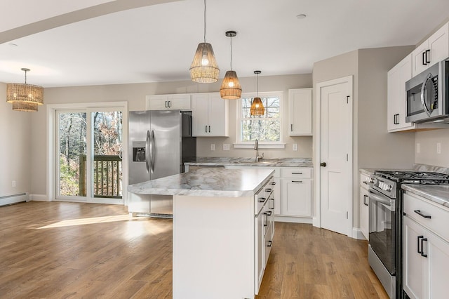 LOT9 Westhaven Ln, Wells, ME 04090 - kitchen with stainless steel appliances, a sink, light wood-style flooring, a center island, and healthy amount of natural light