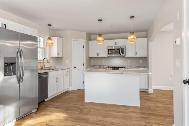LOT9 Westhaven Ln, Wells, ME 04090 - kitchen with stainless steel appliances, white cabinetry, a sink, light countertops, and light wood finished floors