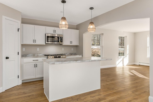 LOT9 Westhaven Ln, Wells, ME 04090 - kitchen with stainless steel microwave, a baseboard heating unit, range, light wood-type flooring, and white cabinetry